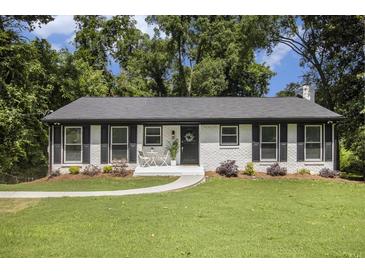 Charming, freshly painted single-story home with black shutters, landscaping, walkway, and inviting front entry at 2358 Armand Ne Rd, Atlanta, GA 30324