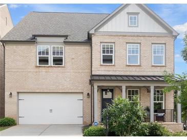 Charming two-story home featuring a brick facade, inviting porch, and a well-manicured front yard at 635 Opera Ln, Alpharetta, GA 30009