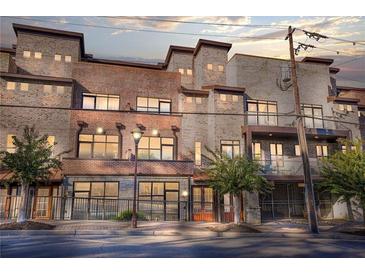 Beautiful multi-story brick building with large windows and wrought iron details at 1199 Huff Nw Rd # 112, Atlanta, GA 30318