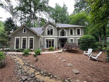 Charming two-story traditional home with inviting front yard, stone walkway, and manicured landscaping at 3962 Fox Glen Dr, Woodstock, GA 30189
