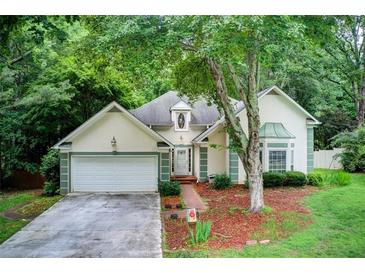 Charming home exterior with lush landscaping and a welcoming facade at 652 Trailwood Sw Ln, Marietta, GA 30064