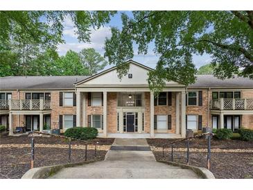 Brick condominium building featuring stately pillars and nicely landscaped common areas at 3650 Ashford Dunwoody Ne Rd # 811, Atlanta, GA 30319