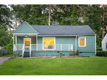 Charming bungalow-style home with covered porch, green lawn, and mature trees at 1170 Westmont Sw Rd, Atlanta, GA 30311