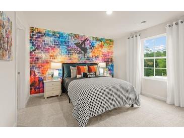 Bright bedroom with an artistic accent wall, soft carpet, and lots of natural light from the large window at 7225 Lacey Lot 147 Dr, Douglasville, GA 30134