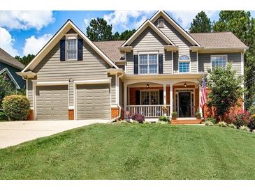 Charming two-story home with a well-maintained front yard, manicured lawn, and a welcoming front porch at 1120 Bentwater Dr, Acworth, GA 30101