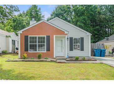 Charming single-story home with brick and siding, complemented by well-maintained landscaping and black window shutters at 2026 Patterson Park Pl, Lawrenceville, GA 30044