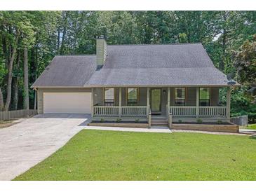 Charming single-story home with a welcoming front porch and a well-maintained front yard at 680 Spirit Falls Way, Johns Creek, GA 30022