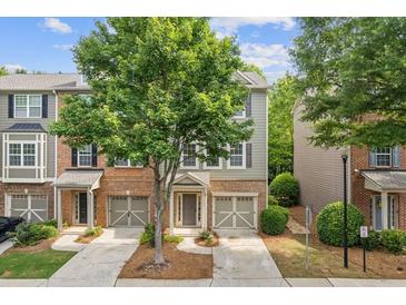 Charming townhome with a well-manicured lawn and an attached garage at 1464 Dolcetto Trce, Kennesaw, GA 30152