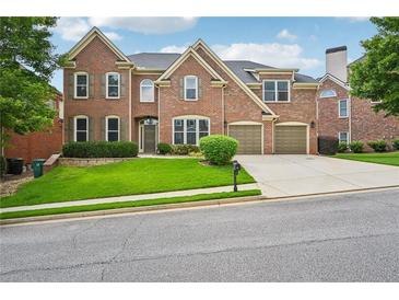 Beautiful brick two-story home with well-manicured lawn and a two-car attached garage at 5066 Healey Dr, Smyrna, GA 30082