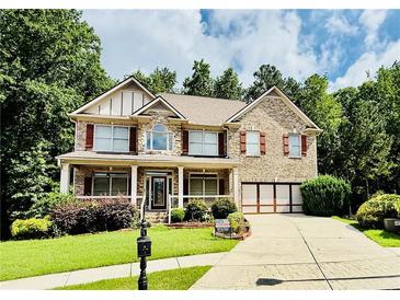 Charming two-story brick home with well-manicured lawn and inviting curb appeal at 1652 Park Hollow Ln, Lawrenceville, GA 30043