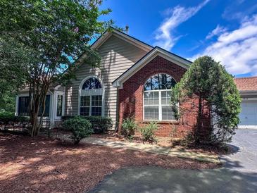 Charming home featuring brick and siding exterior, beautiful landscaping, and large windows, offering curb appeal at 3836 Vineyards Lake Nw Cir # U17, Kennesaw, GA 30144