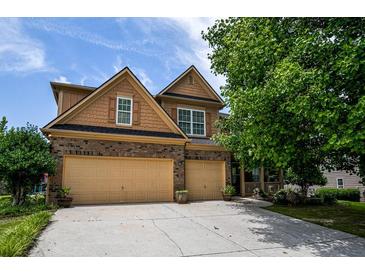 Charming two-story home with a well-manicured lawn and a spacious two-car garage at 4032 Duran Ln, Auburn, GA 30011