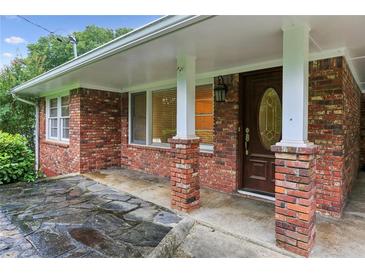 Charming brick home featuring a covered front entry with brick columns at 2711 Fairlane Dr, Atlanta, GA 30340