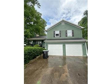 Two-story home featuring a two-car garage and traditional curb appeal at 49 Patty Dr, Dallas, GA 30157