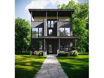 Modern two-story home featuring large windows, a sleek black facade, and lush greenery at 655 Willoughby Ne Way, Atlanta, GA 30312