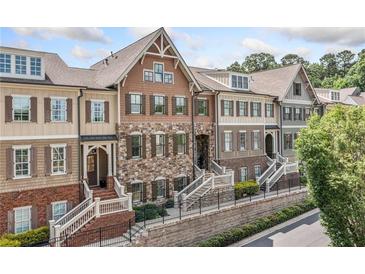 Charming townhome exteriors with brick and stone accents, featuring landscaped front yards and inviting entryways at 406 Mareeba Park # 61, Canton, GA 30114