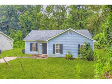 Charming single-story home featuring a well-maintained lawn and traditional architectural details at 7127 Greenway Sw Cv, Covington, GA 30014