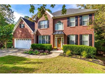 Beautiful two-story brick home with a manicured lawn, tasteful landscaping, and an attached two-car garage at 2540 Ridgehurst Dr, Buford, GA 30518