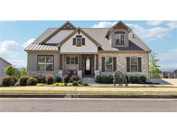 Charming exterior view of a two-story home with stone accents and a landscaped front yard at 413 Horizon Trl, Canton, GA 30114