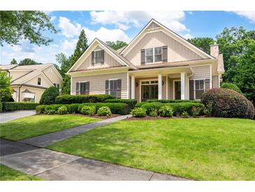 Charming home featuring a well-manicured lawn and lovely, trimmed greenery and sidewalk to the front door at 6186 Talmadge Nw Run, Acworth, GA 30101