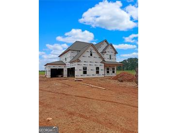 New two-story home construction featuring visible framing and Tyvek house wrap on a sunny day at 1500 Alcovy Station Rd, Covington, GA 30014