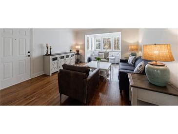 Inviting living room boasts hardwood floors and plenty of natural light from the many windows at 115 Peachtree Memorial Nw Dr # C1, Atlanta, GA 30309