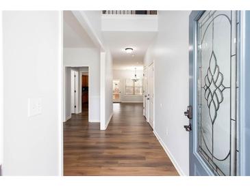 Inviting hallway features hardwood floors and a decorative glass front door at 264 Ascott Ln, Woodstock, GA 30189
