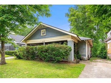 Charming bungalow with blue siding, covered front porch, and a well-maintained lawn at 1639 Rogers Sw Ave, Atlanta, GA 30310