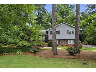 Charming two-story home with well-maintained lawn and landscaping at 687 Monticello Se Way, Marietta, GA 30067