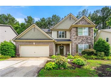 Charming two-story home featuring brick and stone accents, a well-manicured lawn, and a two-car garage at 58 Lilyfield Ln, Acworth, GA 30101