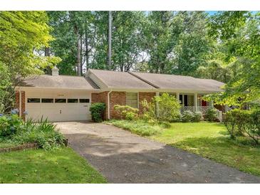 Charming brick ranch home with a two-car garage and lush landscaping at 1618 Mason Mill Ne Rd, Atlanta, GA 30329