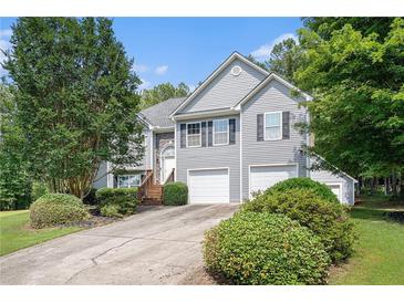 Charming two-story home with a manicured front yard and a two-car garage at 40 Browning Dr, Covington, GA 30016