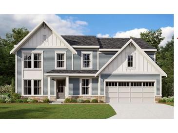 Charming two-story home featuring light blue siding, white trim, a two-car garage, and well-manicured lawn at 216 Willow Bend Rd, Hiram, GA 30141