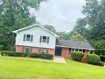 Charming two-story home with a brick-and-siding exterior and well-manicured landscaping at 3755 Greentree Dr, Decatur, GA 30032