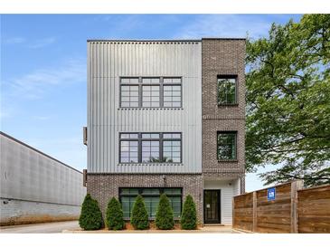 Modern exterior with brick and silver facade, complemented by well-placed windows and manicured greenery at 417 E College Ave # 302, Decatur, GA 30030