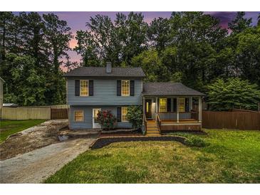 Charming two-story home with a welcoming front porch and nicely landscaped yard at 4835 Kellys Mill Nw Dr, Lilburn, GA 30047
