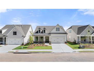 Charming single-Gathering home boasting a manicured lawn, stone accents, and a welcoming covered porch at 1649 Tielman Way, Snellville, GA 30078