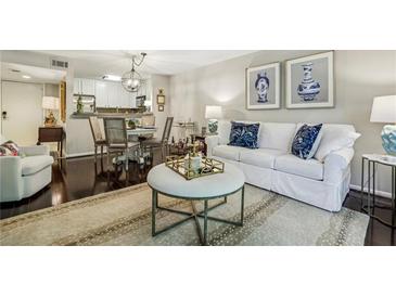 Bright living room featuring a white sofa, stylish decor, and hardwood floors at 3650 Ashford Dunwoody Ne Rd # 1024, Atlanta, GA 30319