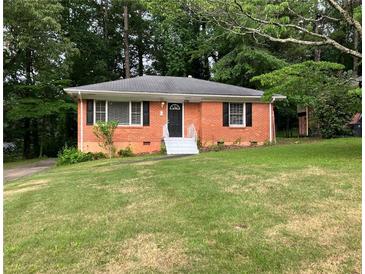 Charming single-story brick home with a well-maintained lawn and mature trees at 3160 Delowe Dr, Atlanta, GA 30344