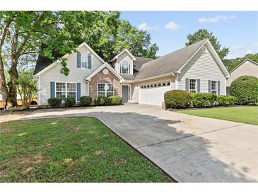 Charming traditional home with manicured lawn, stone accents, and attached two-car garage at 4042 Laurel Bend Ct, Snellville, GA 30039