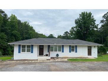 Charming single-story home featuring blue shutters and a well-manicured front yard at 410 S Gordon Sw Rd, Mableton, GA 30126