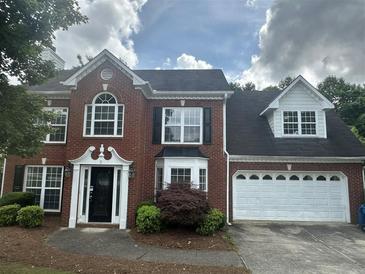 Charming two-story brick home with manicured landscaping and attached two car garage at 4189 Duncan Ives Dr, Buford, GA 30519