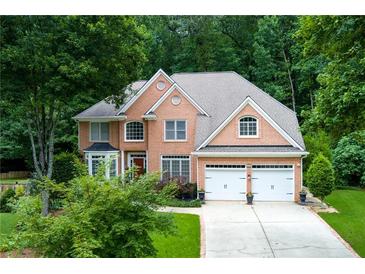 Stunning brick two-story home with a two-car garage and mature trees at 3245 Bywater Trl, Roswell, GA 30075
