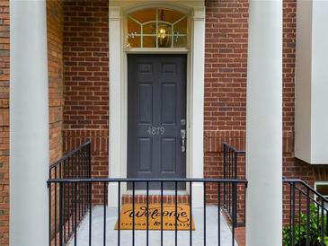Charming brick home entrance with a gray door, transom window, and a welcoming doormat at 4879 Seldon Se Way, Smyrna, GA 30080