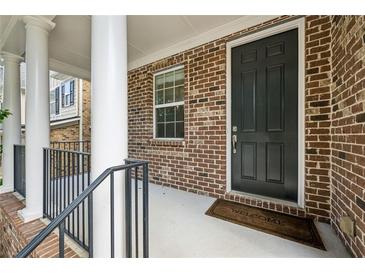 Inviting brick front porch with classic columns and a dark front door, creating a warm welcome at 1648 Danbury Parc Ne Pl, Brookhaven, GA 30319