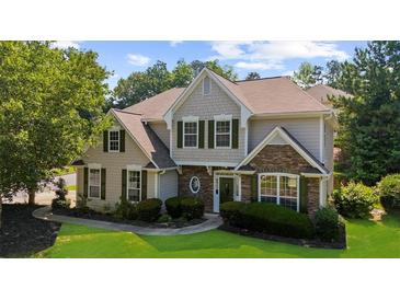 Charming two-story home featuring stone accents, green shutters, and lush landscaping at 3559 Reservoir Pass, Acworth, GA 30101