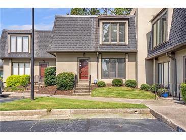 Charming townhome featuring a well-maintained lawn and a classic roof design at 17 Ivy Gates Ne, Atlanta, GA 30342