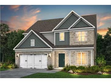Charming two-story home with a brick facade, a two-car garage, and a landscaped yard at 5268 Mulberry Pass Ct, Hoschton, GA 30548