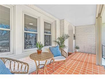 Inviting front porch with beautiful terracotta tile flooring and cozy seating area at 1337 M L King Jr Nw Dr, Atlanta, GA 30314