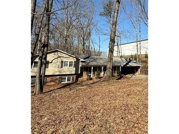 Charming single-Gathering home with a traditional design and a front yard covered in fallen leaves at 3415 Spring Valley Blvd, Atlanta, GA 30349